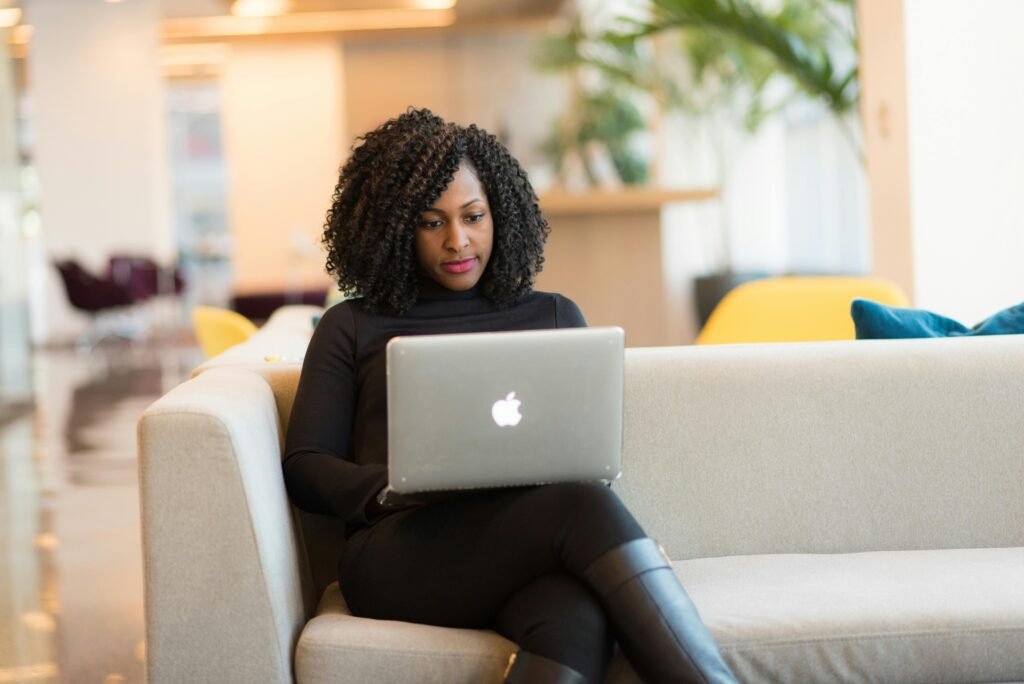 Ready Made Content Woman Using Macbook Sitting on White Couch