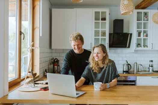 PLR Rights Man and Woman Using a Laptop in the Kitchen Area