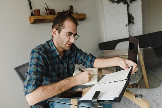 Passive Income A Man in Plaid Shirt Working at Home