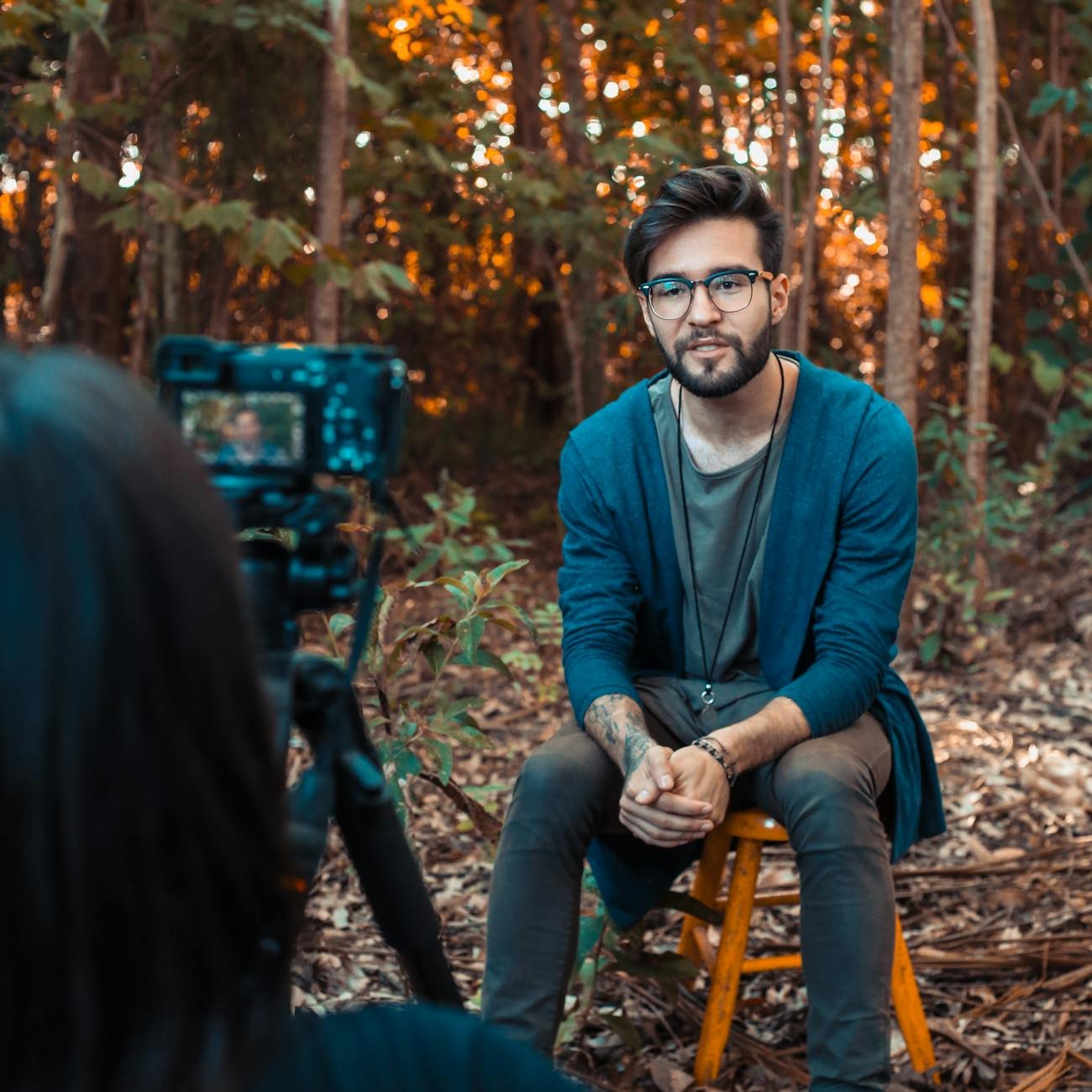 photo of a man sitting in front of a camera plr