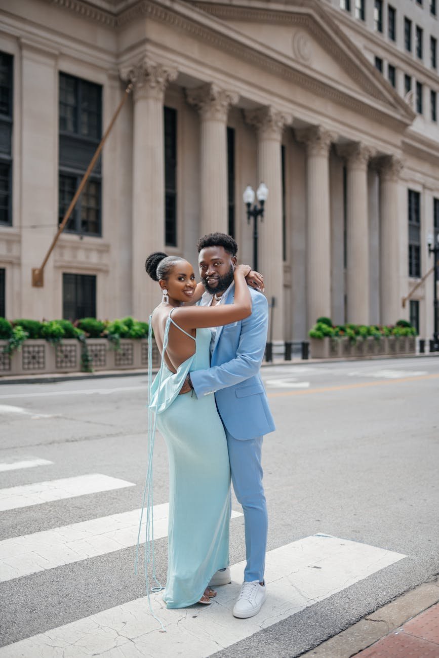 couple hugging on crosswalk near old building