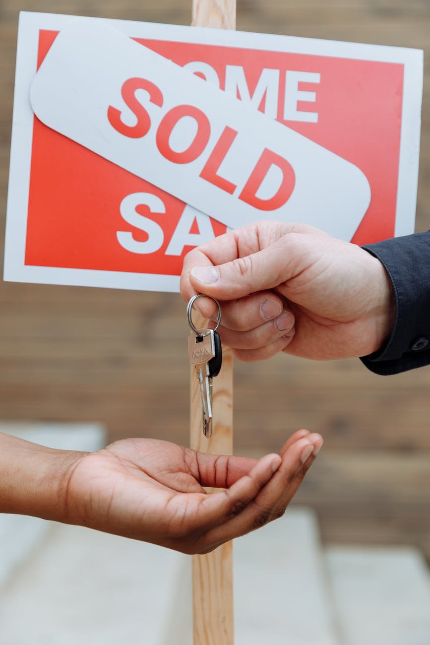 person handing out keys to another person