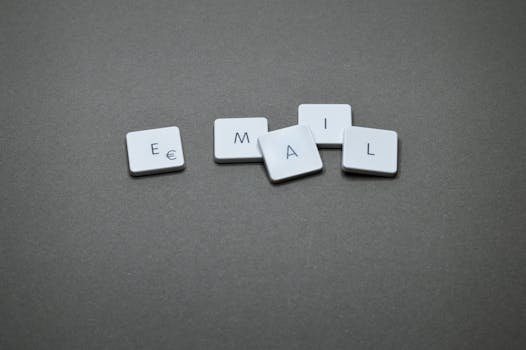 email list Close-up of the word 'email' formed with letter tiles on a gray surface.